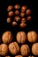 Whole walnuts and cleared on old black metal background, top view. Space for text