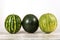 Whole watermelons of different varieties on a white background.