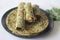 Whole wheat methi thepla rolls with paneer capsicum filling and a bowl of masala curd