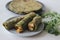 Whole wheat methi thepla rolls with paneer capsicum filling and a bowl of masala curd