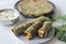 Whole wheat methi thepla rolls with paneer capsicum filling and a bowl of masala curd