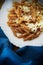 Whole wheat pasta and cauliflower plate by a blue napkin