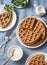 Whole wheat savory breakfast viennese waffles, cream and milk on blue background