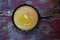 Whole Yellow Cornbread in cast iron skillet on rustic wood table closeup top view with copy space