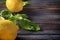Whole yellow juicy lemons, Basil on a dark wooden background, citrus