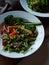 Wholefoods rustic vegetable dish on wooden table in natural light