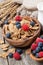 Wholegrain flakes with fresh berries on wooden table, close-up