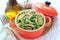 Wholegrain pasta with green vegetables in ceramic pan