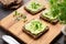 Wholegrain sandwiches with avocado spread and microgreens