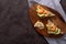 Wholegrain toast bread slices with guacamole, fried shrimp and fried bacon pieces on wooden board Selective Focus, Focus on the