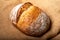 Wholemeal sourdough bread isolated on burlap cloth.