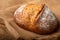 Wholemeal sourdough bread isolated on burlap cloth.