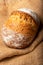 Wholemeal sourdough bread isolated on burlap cloth.