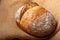 Wholemeal sourdough bread isolated on burlap cloth.