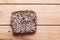 Wholemeal, wholewheat slice of bread on wooden table. Organic, healthy food