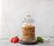 Wholewheat penne pasta in a glass container. close-up. diet concept.