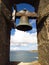 For whom the bell tolls solitary bell in stone arch framing sea view