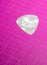 Whtie plastic guitar plectrum on pick background.