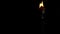 The wick of a kerosene lamp burns in the dark