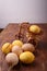 Wicked toy bicycle with yellow painted Easter egg. Some brown eggs on rustic table. Spring and Happy Easter concept. Vertical shot