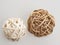 Wicker balls, white and beige, on white background, composition