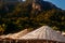 Wicker bamboo umbrellas on ha beach background of mountains