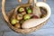 a wicker basket with apples and pumpkins