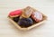 Wicker basket with assorted donuts on wood table top