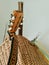 Wicker basket, brown fretboard of a six string wooden guitar