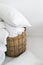 Wicker basket with clean bedding, pillow, blanket