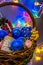 Wicker basket with colored Christmas toys illuminated with festoons.