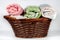 Wicker basket containing hand towels of different colors and patterns