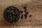 Wicker basket with delicious ripe black mulberries on wooden table, flat lay