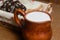 Wicker basket with different sliced bread and a jug of milk on the table. Homely atmosphere