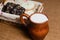 Wicker basket with different sliced bread and a jug of milk on the table. Homely atmosphere