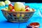 Wicker basket with fresh apples and plums on wooden background