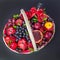 Wicker basket with fruit and a bottle of wine, beautifully decorated on a dark background. concept., congratulations for a holiday