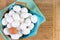 Wicker basket full of white eggs with one brown