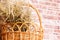 Wicker basket made of natural vine with bouquet of dry herbs for home use. Rural concept, selective focus