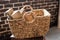 a wicker basket made of paper vine filled with firewood. recycling, eco, natural materials, eco-friendly. boho style