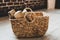 A wicker basket made of paper vine filled with firewood. recycling, eco, natural materials, eco-friendly. boho style, rustic, cozy