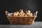 Wicker basket with many Jerusalem artichokes on light grey table