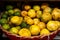 Wicker basket overflowing with bright yellow lemons