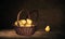 Wicker Basket with pears and one pear on table, dark painting background.