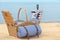 Wicker basket with picnic essentials on sand