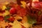 Wicker basket of red apples on the background of autumn leaves