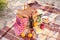 Wicker basket with tasty food and drink for romantic picnic on beach