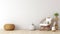 a wicker basket, toys, and a pouf arranged near a clean white wall, representing modern interior design in a minimalist