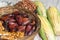 Wicker basket with typical Brazilian foods like pine nuts, popcorn, brown sugar, peanuts and green corn