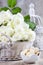 Wicker basket of white roses and bowl of cookies